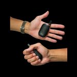 Two hands holding sleek, black cannabis vaping devices against a dark background.