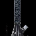 A tall, patterned glass bong with a flared base, accompanied by a downstem and bowl.
