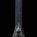Glass bong with intricate geometric pattern and percolated base, isolated on black.