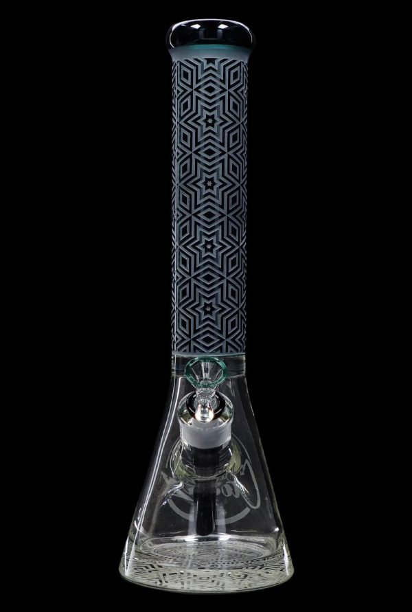 Glass bong with intricate geometric pattern and percolated base, isolated on black.