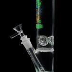 A green glass water pipe (bong) with ice catch and patterned artwork.