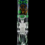 A vibrant green glass water pipe (bong) with a cartoon illustration of a woman wearing sunglasses and a headwrap, surrounded by cannabis leaves.
