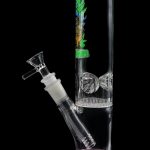 Glass water pipe (bong) with colorful artwork and ice catcher percolators, against a black background.