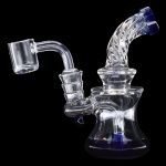 Clear glass dab rig with blue accents and a quartz banger.