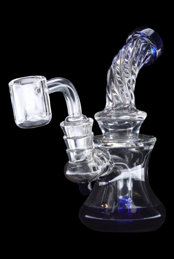 Clear glass dab rig with blue accents and quartz banger.