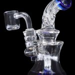 Clear glass dab rig with blue accents and a quartz banger.