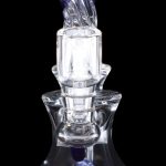 Clear glass dab rig with blue accents, illuminated from within.