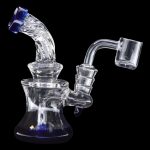 Clear glass dab rig with blue accents and a quartz banger.