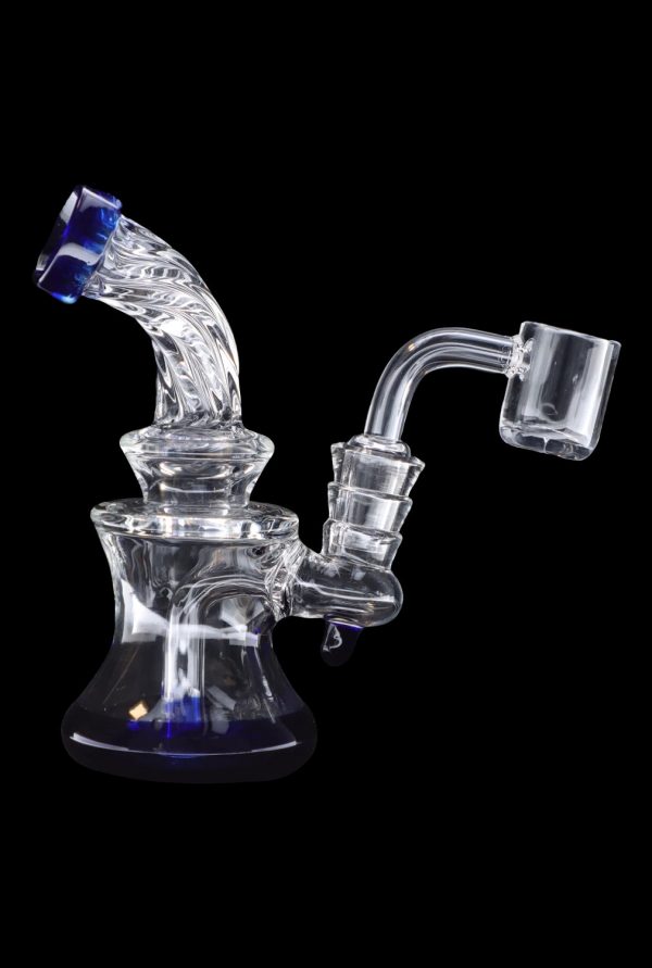 Clear glass dab rig with blue accents and a quartz banger.