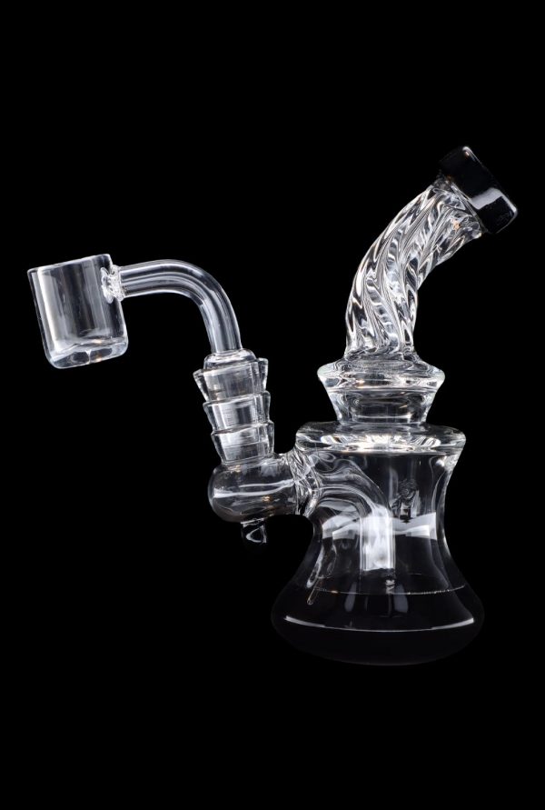 Clear glass dab rig with quartz banger, isolated on black.