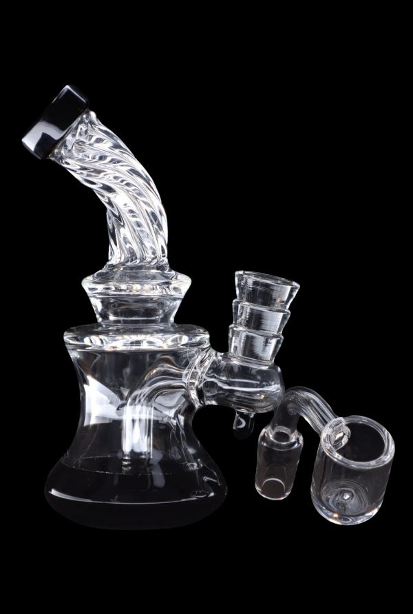 Clear glass water pipe (rig) with attachments against a black background.