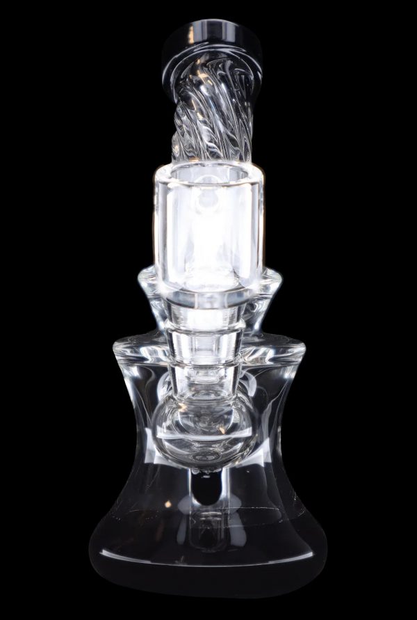 Clear glass dab rig with intricate swirling design, isolated on a black background.