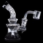 Clear glass dab rig with a quartz banger, isolated on a black background.