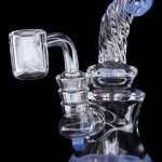 Blue and clear glass dab rig with a quartz banger.