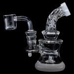 Clear glass dab rig with quartz banger, isolated on a black background.