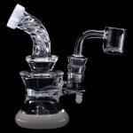 Clear glass dab rig with intricate percolators and a quartz nail, isolated on a black background.