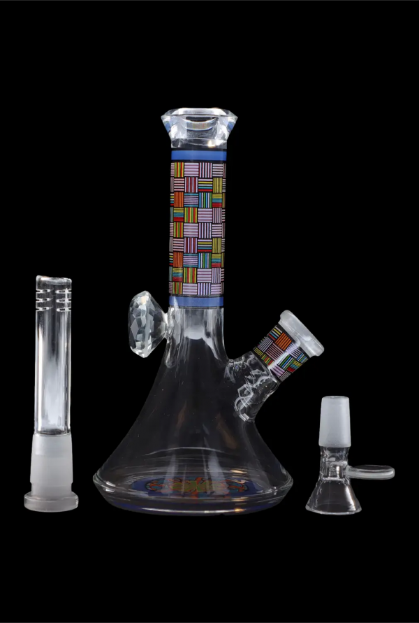 Glass water pipe (bong) with colorful geometric patterns and accompanying glass downstem and bowl, isolated on a black background.