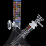Colorful glass bong with patterned accents.