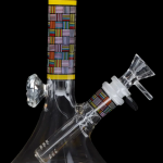 Glass water pipe with colorful geometric patterned accents, isolated on a black background.