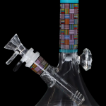 A colorful glass water pipe (bong) with geometric patterns, isolated on a black background.