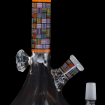 Glass water pipe (bong) with colorful geometric patterns and detachable downstem, isolated on a black background.
