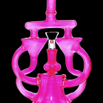 Pink glass water pipe (rig) with ornate, looping design.