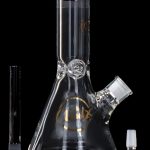 Glass beaker bong with downstem and bowl, isolated on a black background.