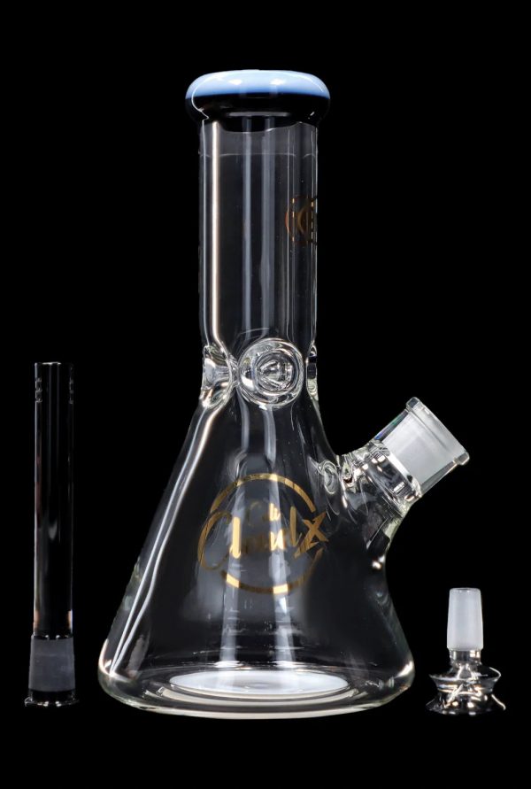 Glass beaker bong with downstem and bowl, isolated on a black background.
