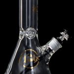 Clear glass water pipe (bong) with ice catcher and patterned detailing, against a black background.