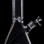 Clear glass bong with ice catcher and angled downstem, isolated on black.