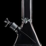 Clear glass bong with green accents, isolated on a black background.