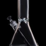 Clear glass bong with green accents against a black background.