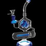 Blue glass water pipe (rig) with intricate sculptural details and a perc filtration system, isolated on a black background.