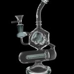 Clear glass water pipe (rig) with intricate hexagonal percolator chamber.