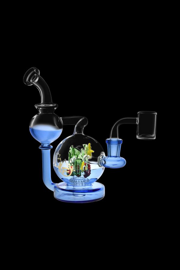 Blue glass dab rig with intricate glass sculpture inside, featuring a matching carb cap.