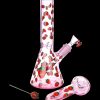 Pink glass water pipe and bowl decorated with strawberries, with a strawberry-shaped tool.