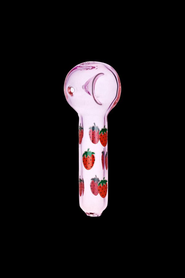 Pink glass pipe decorated with strawberries against a black background.
