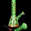 A vibrant green glass bong and pipe decorated with watermelon patterns, accompanied by detached watermelon-shaped glass pieces.