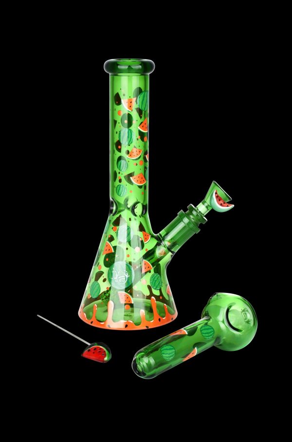 A vibrant green glass bong and pipe decorated with watermelon patterns, accompanied by detached watermelon-shaped glass pieces.