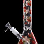 Glass bong with a floral rose pattern against a black background.