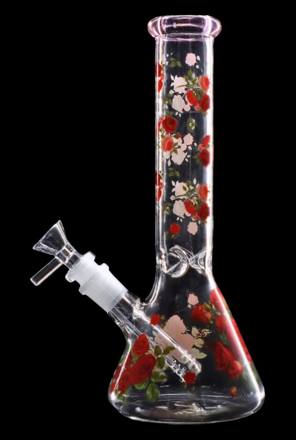 Glass bong with a floral rose pattern against a black background.