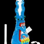 Blue glass water pipe shaped like a monster with sharp teeth, accompanied by a glass downstem and carb cap.