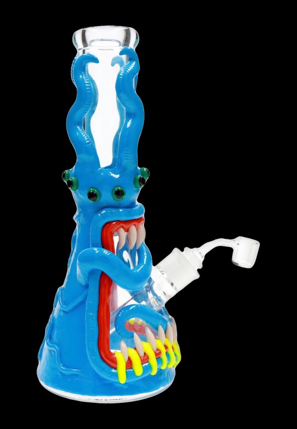 Blue glass water pipe shaped like a monster with glowing red eyes and jagged teeth.