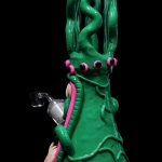 Green glass water pipe shaped like a monster with tentacles and pink accents.