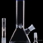 Clear glass bong and accessories on a black background.