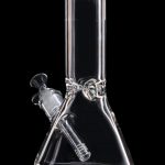 Clear glass bong against a black background.