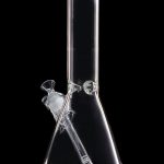 Clear glass bong against a black background.