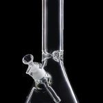 Clear glass bong with a downstem and bowl against a black background.