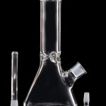 Clear glass bong with downstem and bowl, isolated on a black background.