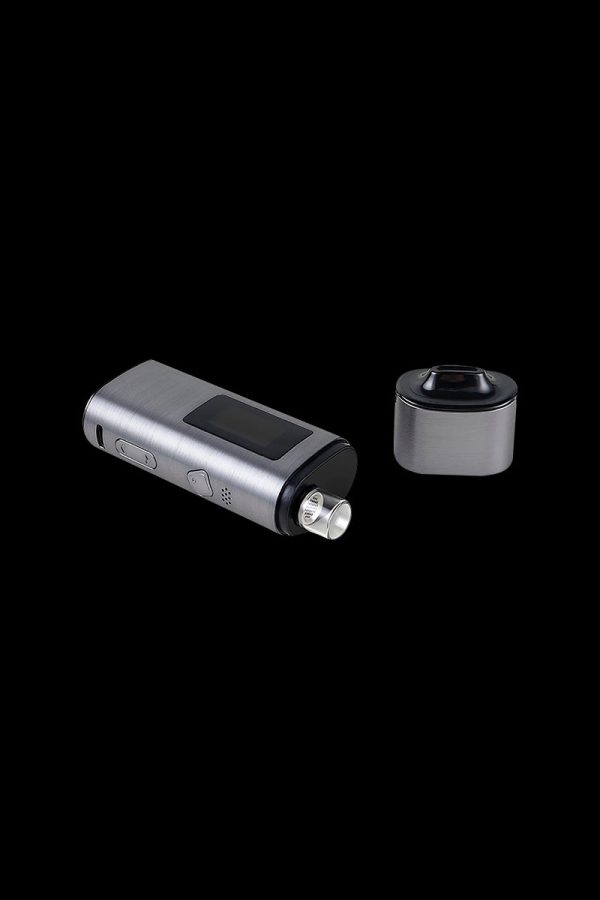 Sleek, silver cannabis vaporizer pen and detachable heating chamber on a black background.